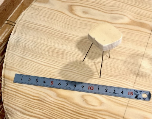 A scale mockup of a stool made of plywood and wire